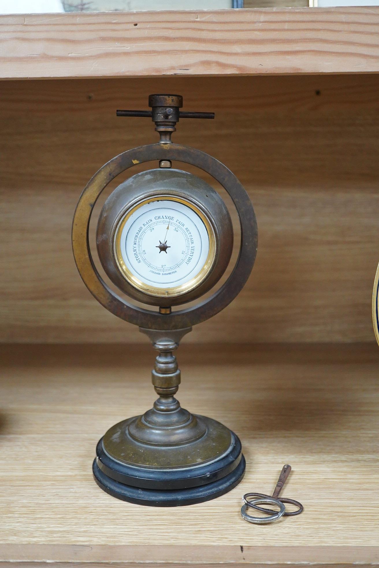 A late 19th century nautical theme brass timepiece barometer, surmounted by a compass, 30cm high